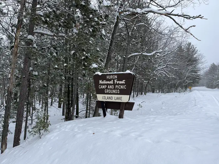A snowy photo of Island lake (MI) sign