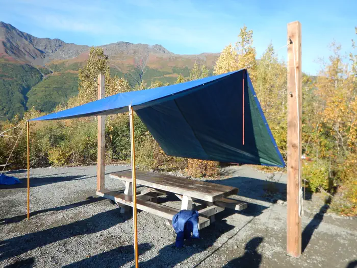 Central camp area with tarp hung from tarp poles.