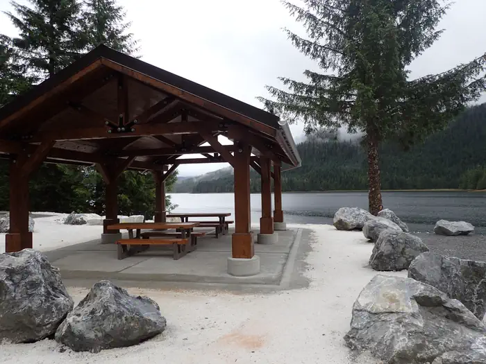 covered shelter with picnic tables and view of ocean