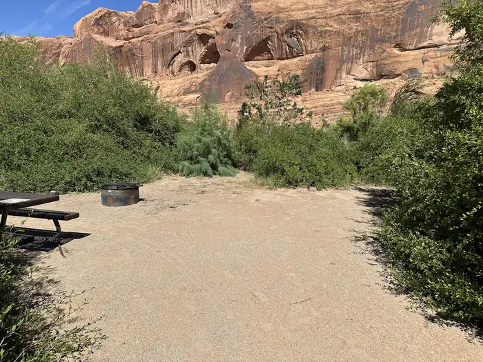There is one picnic table and fire ring with views of the Colorado river and high sandstone cliffs.