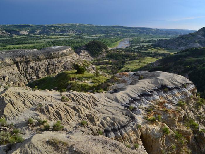 Long range scenic view of barren buttes above a river.