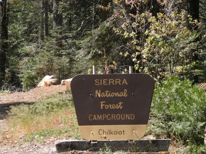 A brown and yellow Forest Sign for Chilkoot Campground on the Sierra National Forest