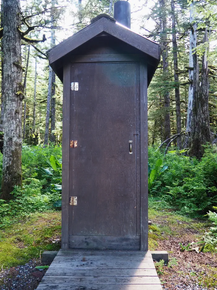 Mount Rynda Cabin outhouse with trees surrounding