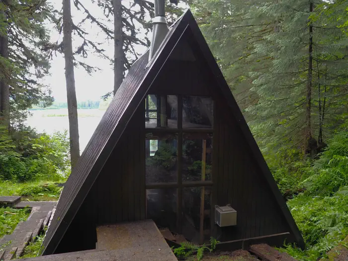 Mount Flemer Cabin exterior from behind showing water and trees in front