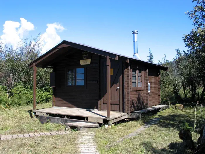 Koknuk cabin with two wood plank trails leading to it