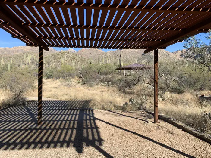 Slatted covered area with no picnic table under