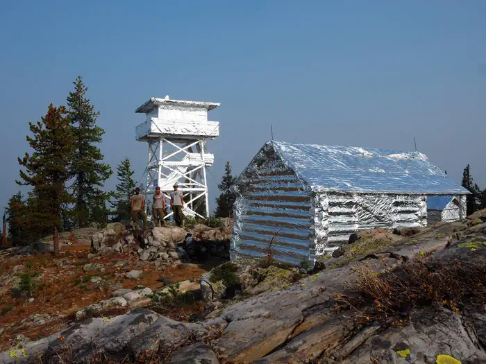 Lookout and cabin wrapped with fire resistant material