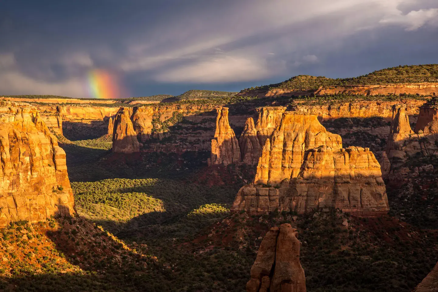 Rainbow and clouds above Monument Canyon