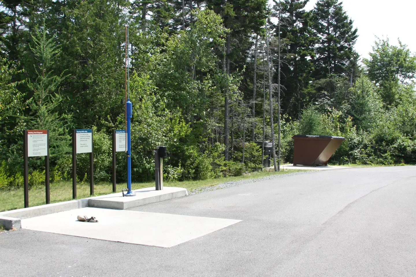 Clean and orderly waste dumping station with fresh water filling station nearby.