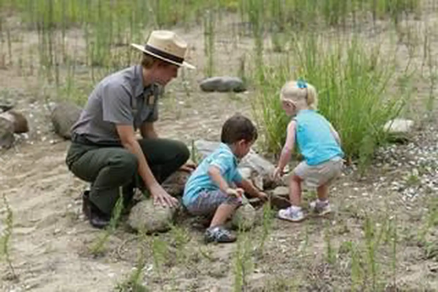 Park ranger with kids in the nature play area at the Paul H Douglas Center area in the Indiana Dunes National Park.