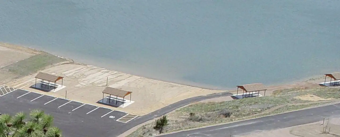 Beach/swimming area at BLM White Sandy Campground. 2 shade structures within the sandy beach area and 2 shade structures adjacent to the swimming area. These 4 shade structures are for day-use only.