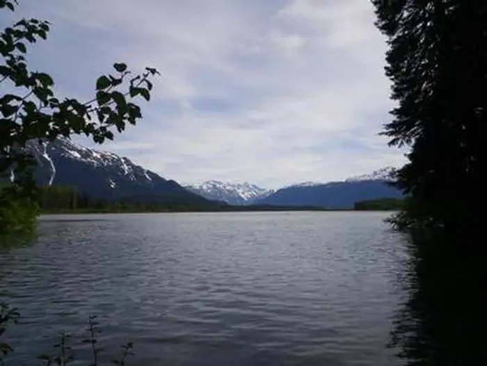 Mount Flemer Cabin scenery with water and snowcapped mountains