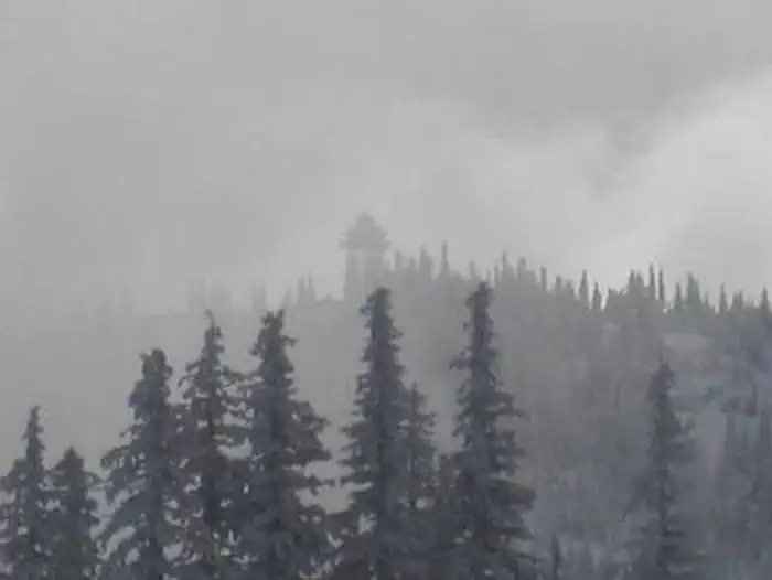 snowy lookout in the distance with fog