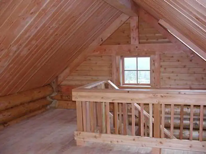 Middle Ridge Cabin interior showing wood stairs to loft